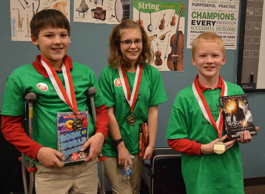 3 students with their medals and books for the Accelerated Reader national record