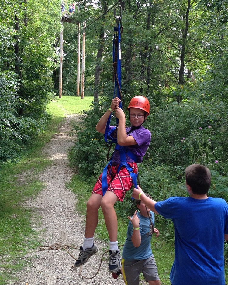 Student zip-lining at Eagle Bluff.