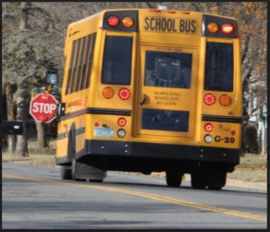 School bus with stop sign out.