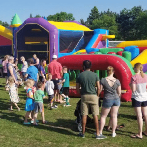 Students waiting in line for the bouncy houses during the spring carnival.